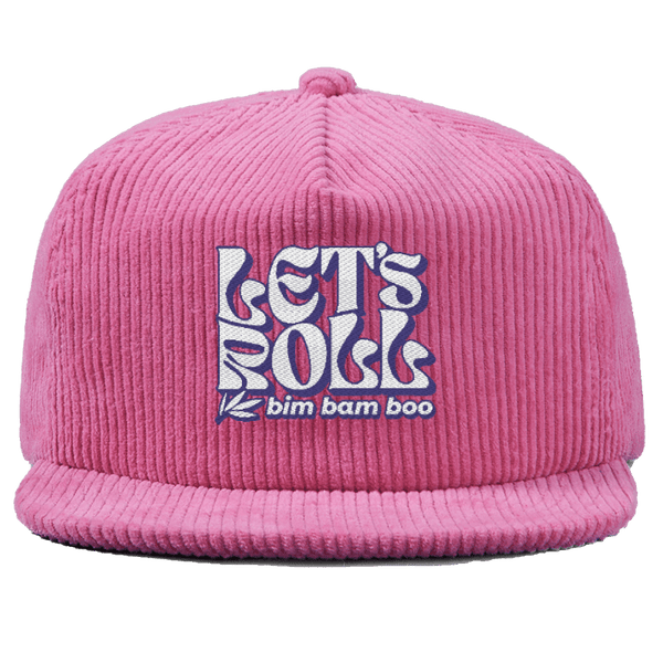 Close up of a pink corduroy baseball hat with the words
