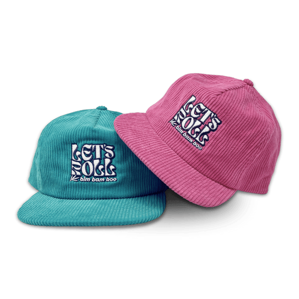Close up of two corduroy baseball  hats with the words