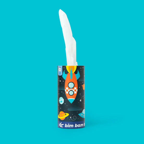 Cylindrical tissue box with a space-themed design featuring a rocket ship